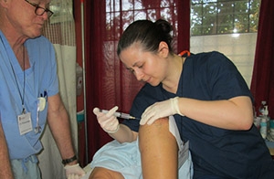 Alexandra (Sasha) Ilkevitch, MD, the first recipient of the Gallagher Scholarship for Prolotherapy, practices the technique during a service-learning trip to Honduras.
