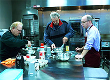 Brian Arndt, MD, (on right) prepares a meal with two participants in the Prairie Kitchen Cooking Club.