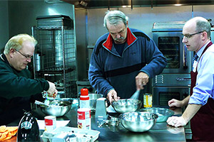 Brian Arndt, MD, (on right) prepares a meal with two participants in the Prairie Kitchen Cooking Club