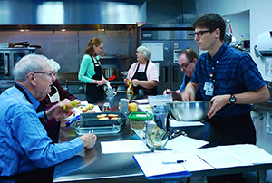 DFMCH resident Jared Dubey, DO, (on right) also helps lead the Prairie Kitchen Cooking Club.