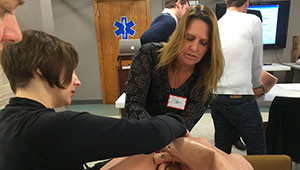 Ildi Martonffy, MD, oversees an ALSO® course participant practicing a normal delivery.