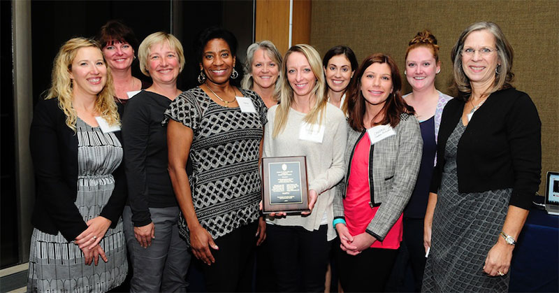 Above, the Davis Award-winning team. From left: Erin MacMillan, RN; Rhonda Lang, RN; Lisa Simpson, PA-C; Trina Copus, Clinic Manager; Linda Kiefer, RN, Nurse Manager; Elizabeth Paape, RN; Jackie Gerhart, MD; Candice Rockwell, RN; Brianna Matheson, MA; Kathy Seymer, RN, MSHI, Director of Primary Care Operations