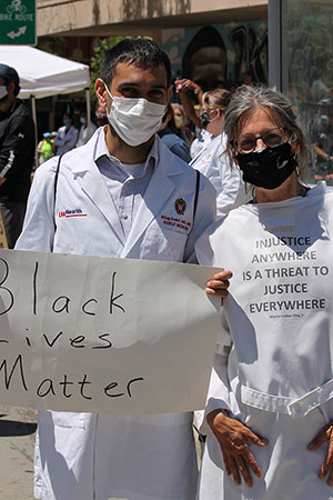 Milap Dubal, MD, and Claire Gervais, MD, participate in the White Coats for Black Lives rally in Madison. 