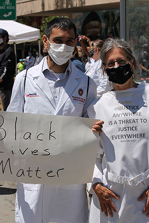 Milap Dubal, MD, and Claire Gervais, MD, participate in the White Coats for Black Lives rally in Madison.