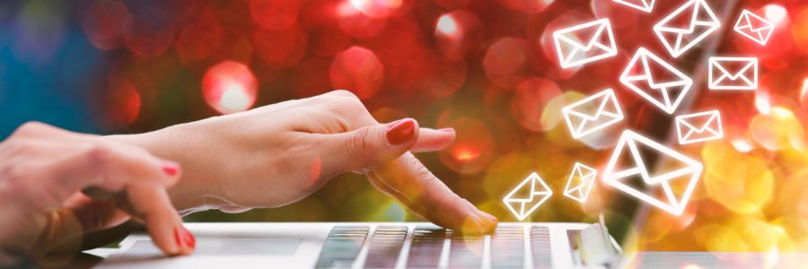 Hands typing email marketing.