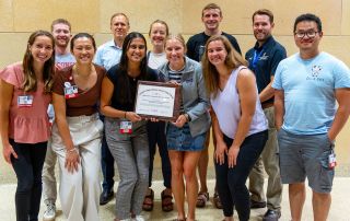 FMIG students pose with 2024 Program of Excellence certificate.