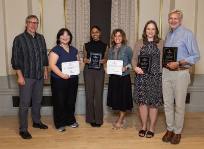 Group photo of six people with winners holding awards.