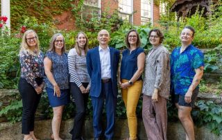Office of Community Health team standing in a garden.