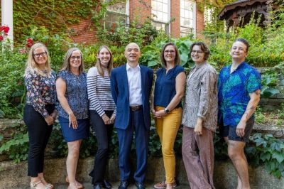 Office of Community Health team standing in a garden.
