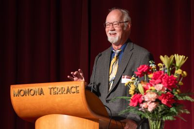 Dr. Lou Sanner at podium.