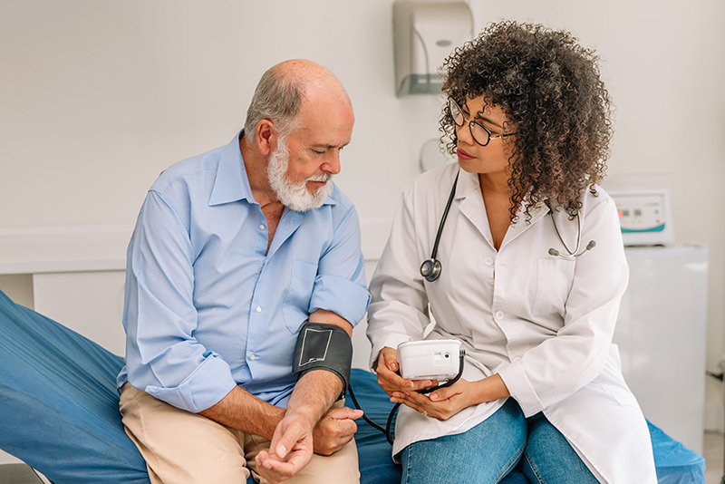 A doctor taking a patient's blood pressure.